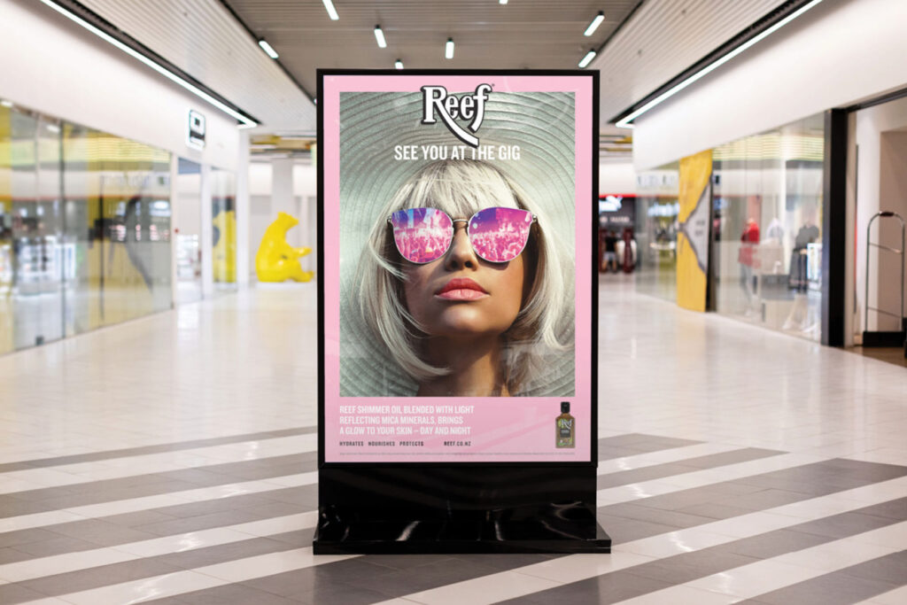 Poster for Reef inside mall of woman wearing sunglasses. Text says 'See you at the Gig'